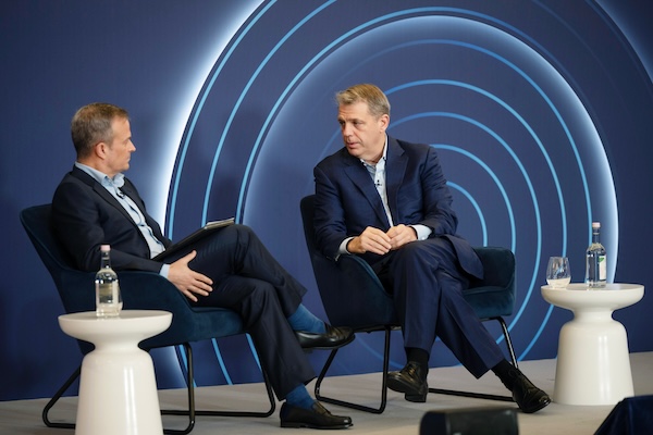 Todd Boehly (right), co-founder, chairman and CEO of Eldridge Industries, talks to Gavin Deane, Global Head of Technology, Media and Telecoms for Deutsche Bank's Investment Bank