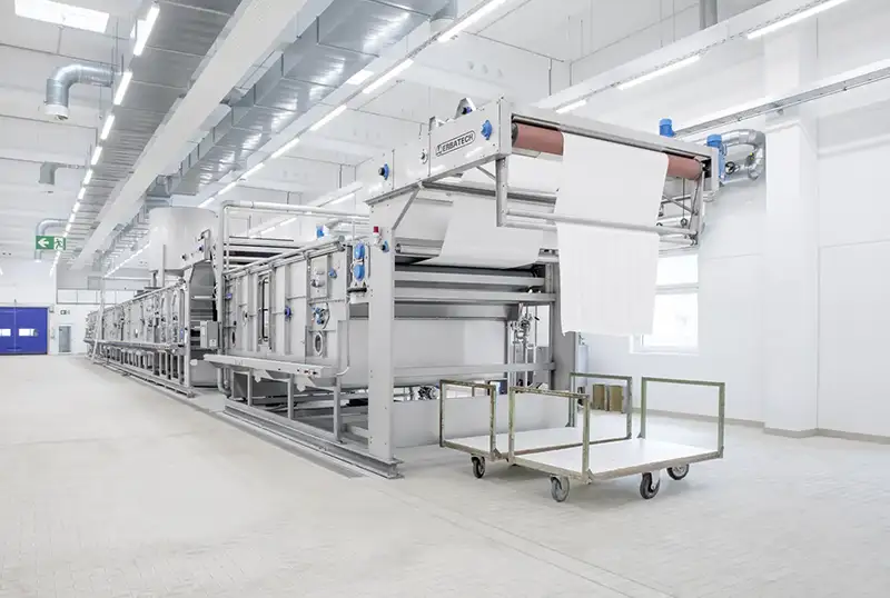 For the finishing step, the material passes through dyeing or bleaching machines.