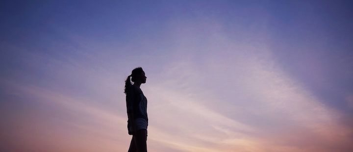 Silhouette of a woman against the horizon