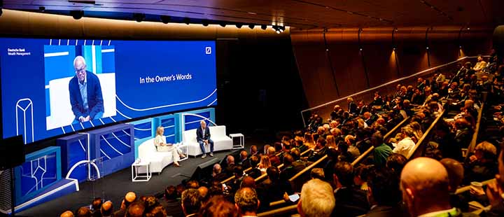 Audience watching speakers at a sports investment conference.