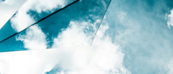 Glass against cloudy sky