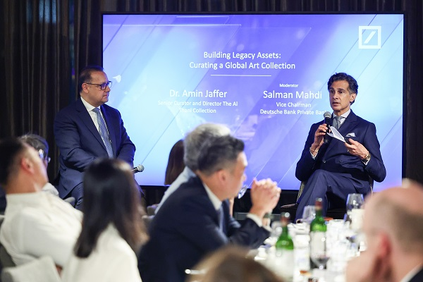 Panel discussion with speakers on stage at event.