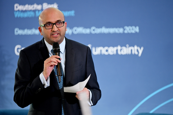 Speaker addressing an audience at the Deutsche Bank London Family Office Conference 2024.