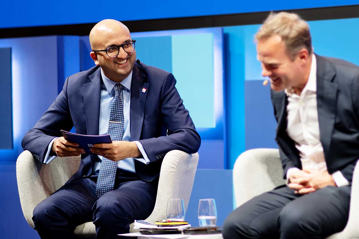 Participants interacting at a London family office conference, discussing cross‑border investments and wealth planning